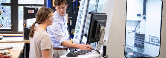 Male professor showing a female student a new innovation