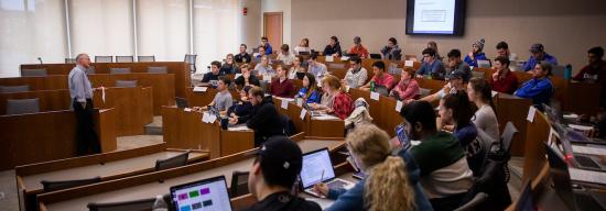 Male professor lecturing students on marketing concepts