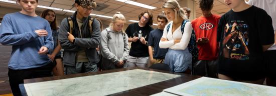 Students looking at a world map