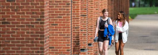 Two female students walking and talking