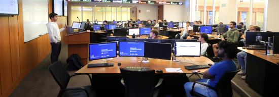 Student presenting in the financial hub of the Gatton College of Business and Economics