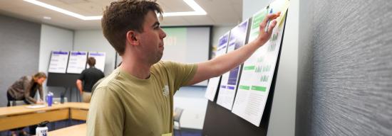 Male student looking at a data chart