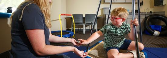 Clinician attending to a child with a developmental disability