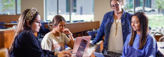 Professor helping students on a topic