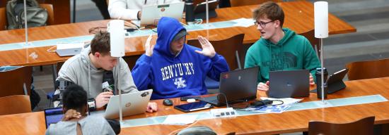 Male students talking in the atrium of the Gatton College of Business and Economics