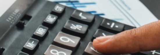 Person pointing at a calculator