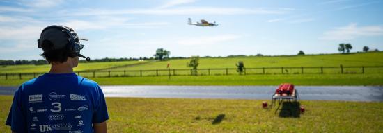 Student observing a plane flying