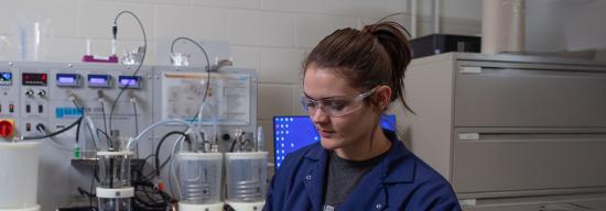 Female conducting an experiment
