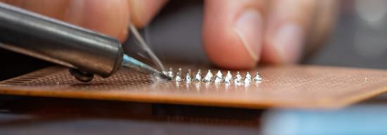 Student working with metal objects