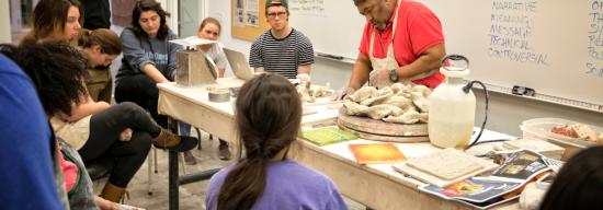Teacher illustrating to students an historical art concept