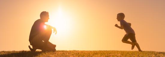 Son running to his father in the sunset
