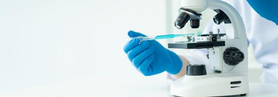 Person using scope to inspect a substance