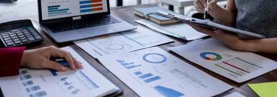 Students analyzing business reports
