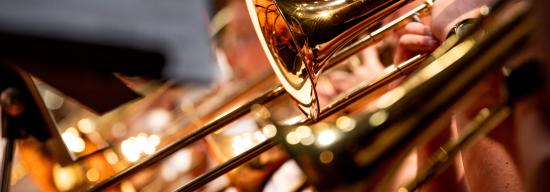 Several students playing the trumpet during a concert