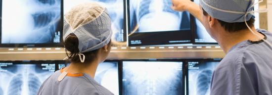 Two medical professionals looking at X-rays