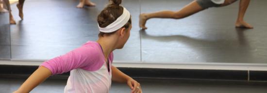 Female stretching in front of a mirror