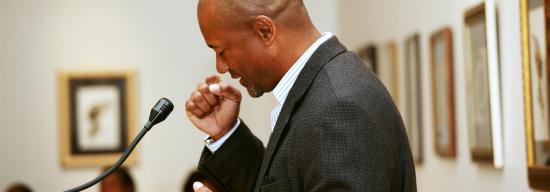 Man preparing to speak on a podium