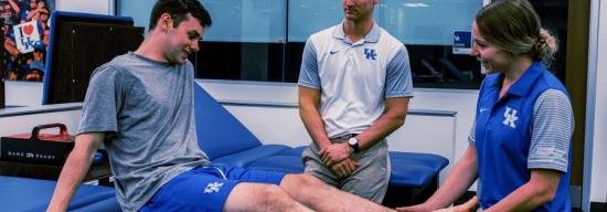 Physical trainers helping an athlete out