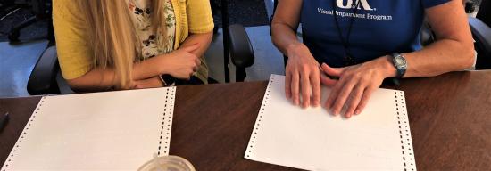 hands reading brail